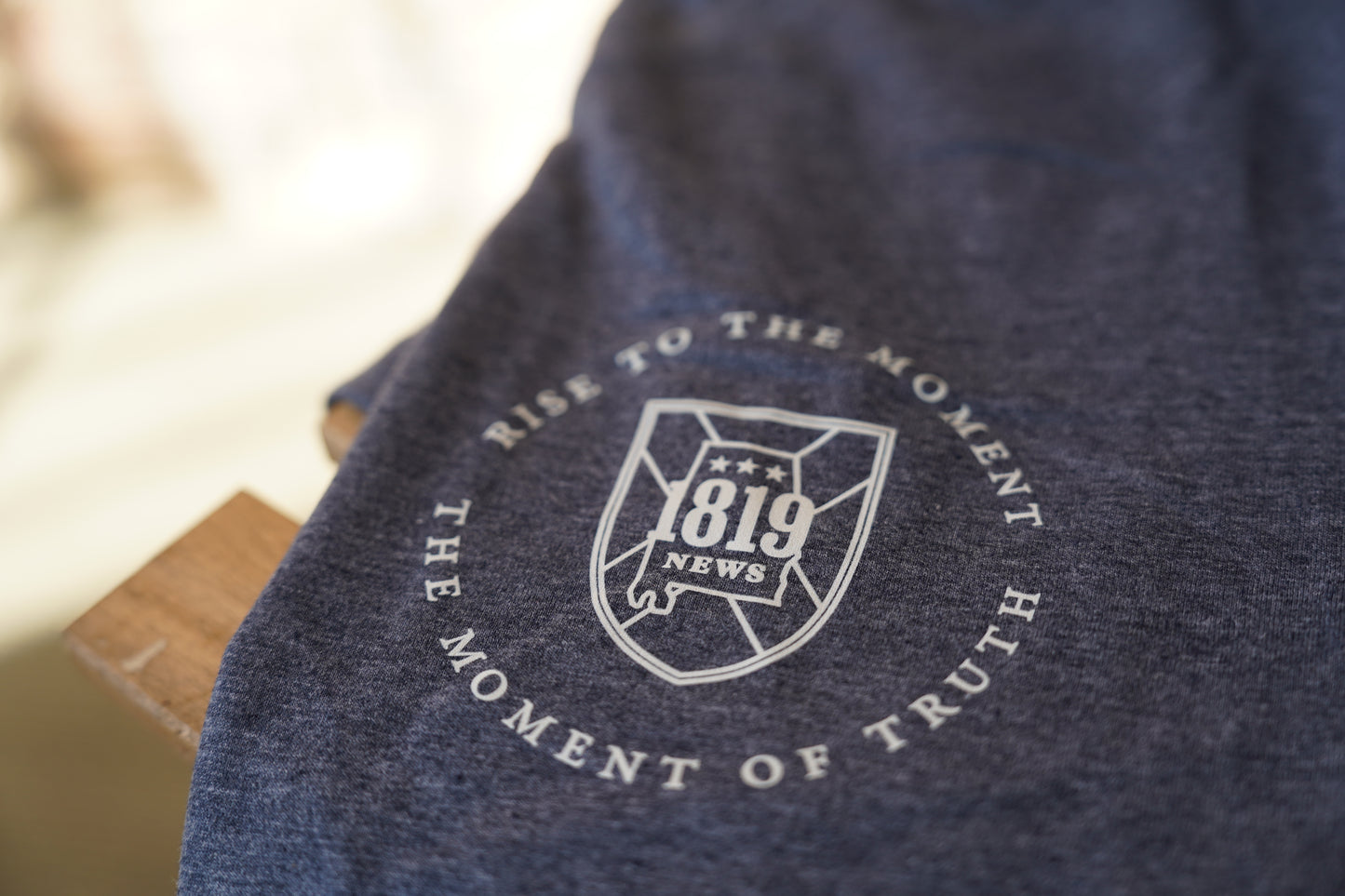 Navy blue fabric with a pocket logo and text on a blurred background