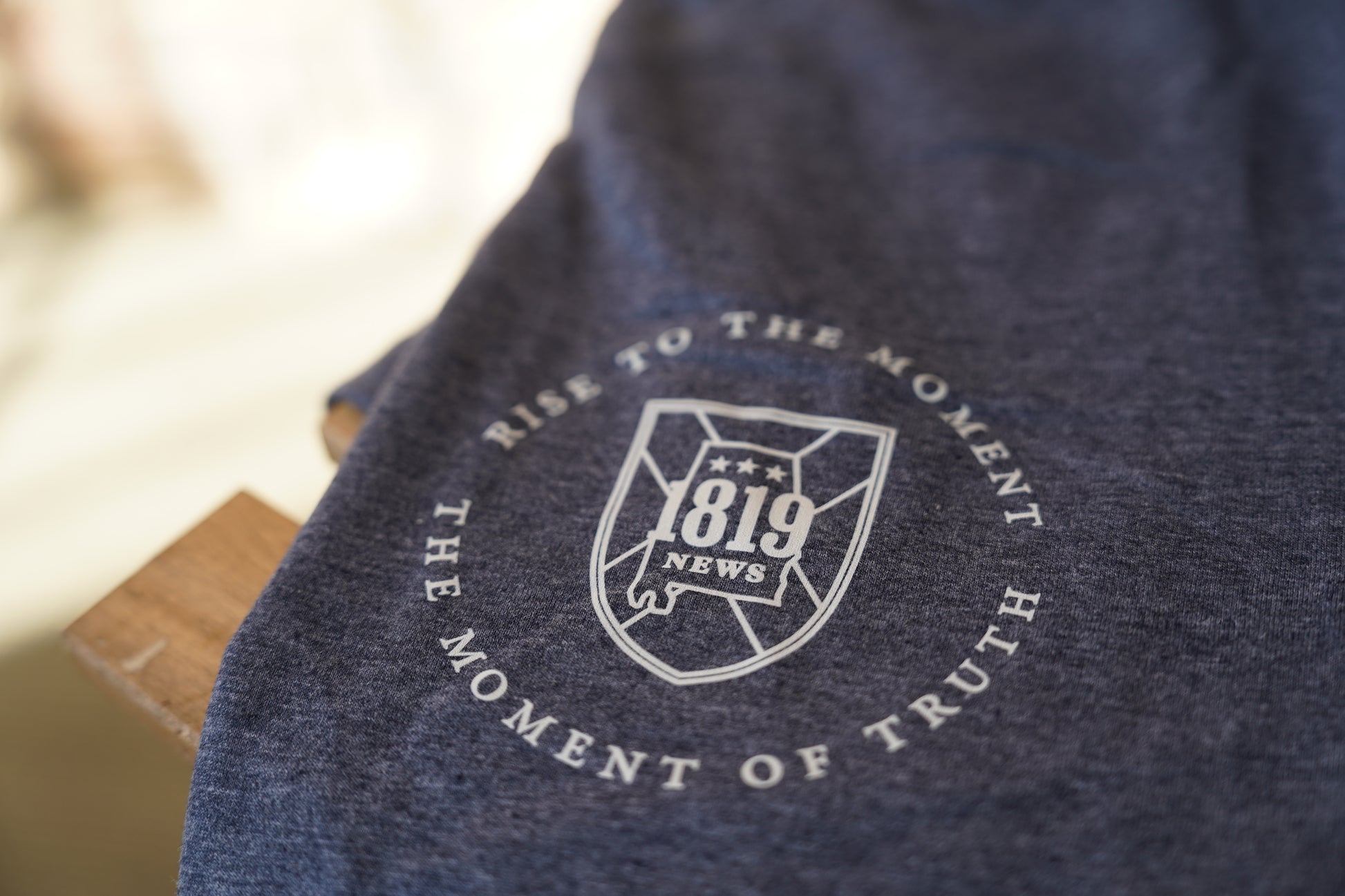 Navy blue fabric with a pocket logo and text on a blurred background