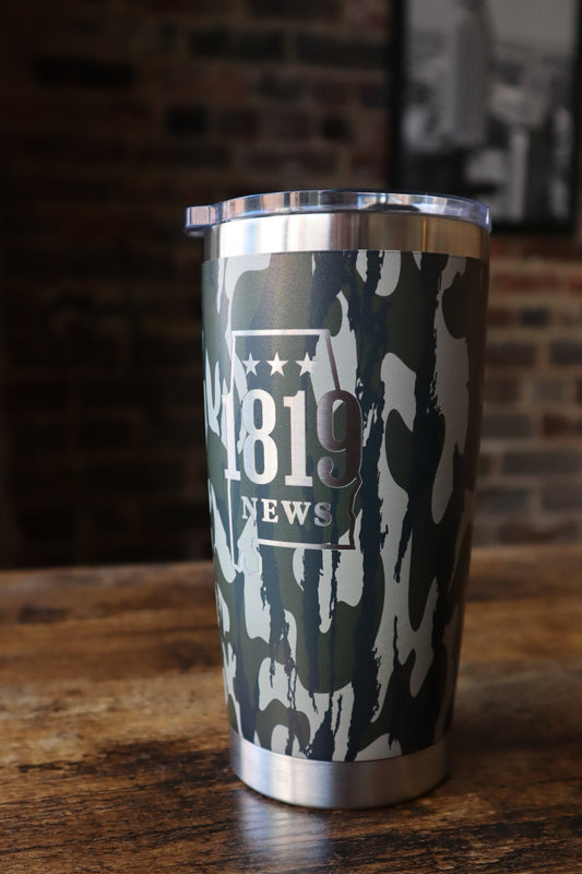 Metallic cylindrical object with camouflage pattern and '1819 NEWS' branding.