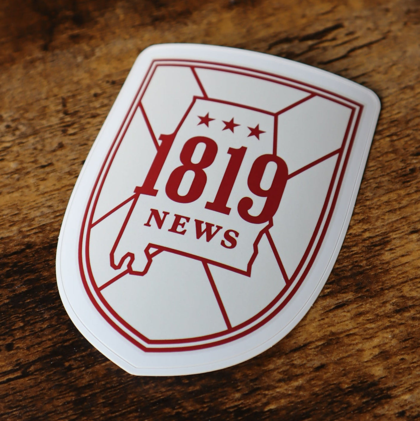 Sticker with '1819' design on a wooden surface